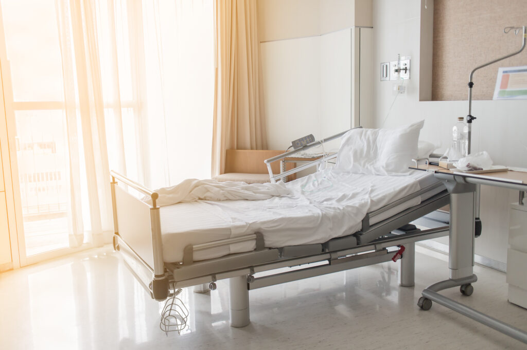 Soft focus background of electrical adjustable patient bed in hospital room